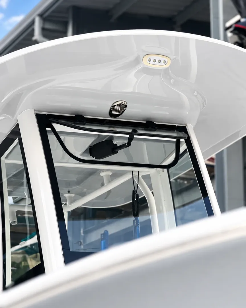 A clean, streak-free windshield under a white hardtop